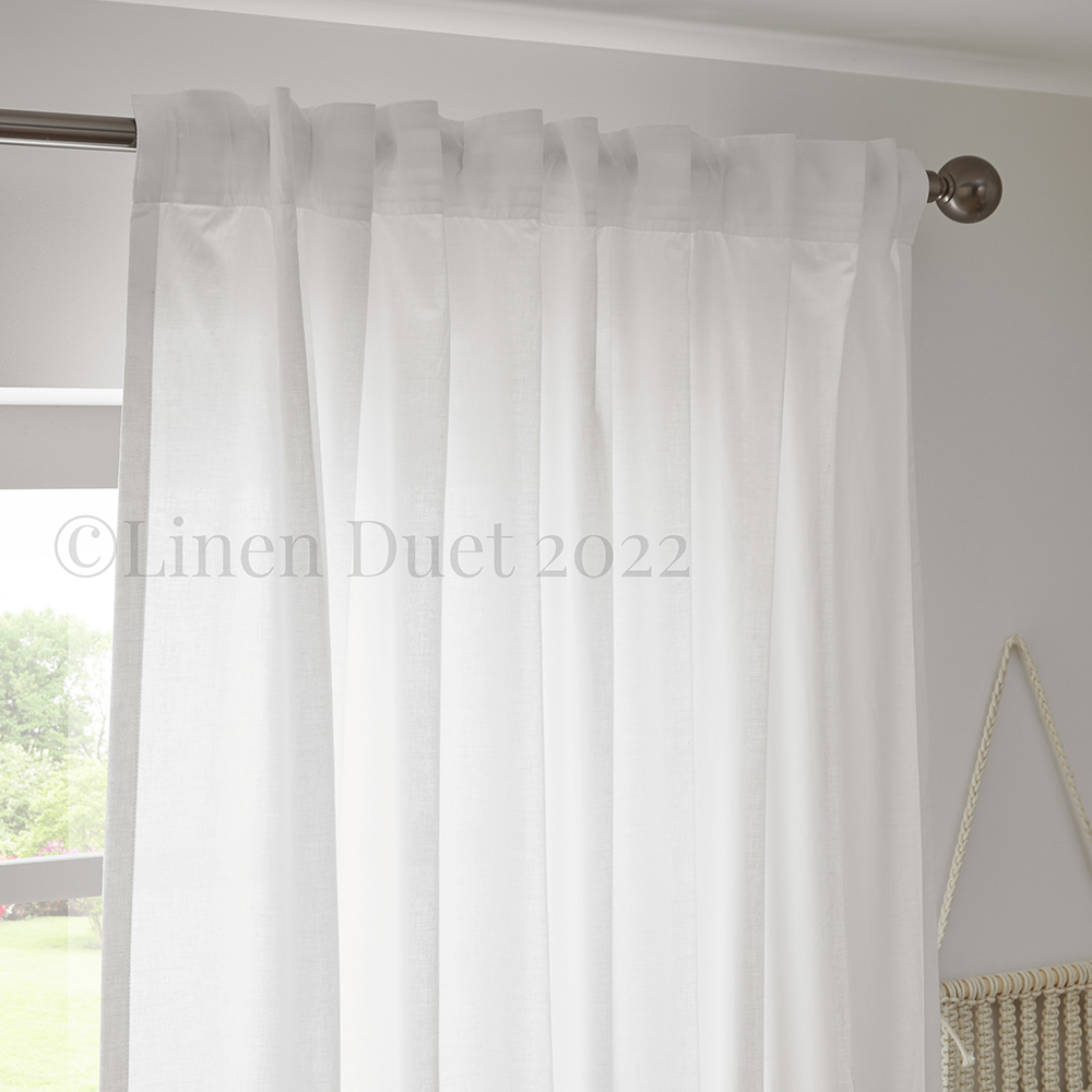 White cotton curtains with back tabs detail